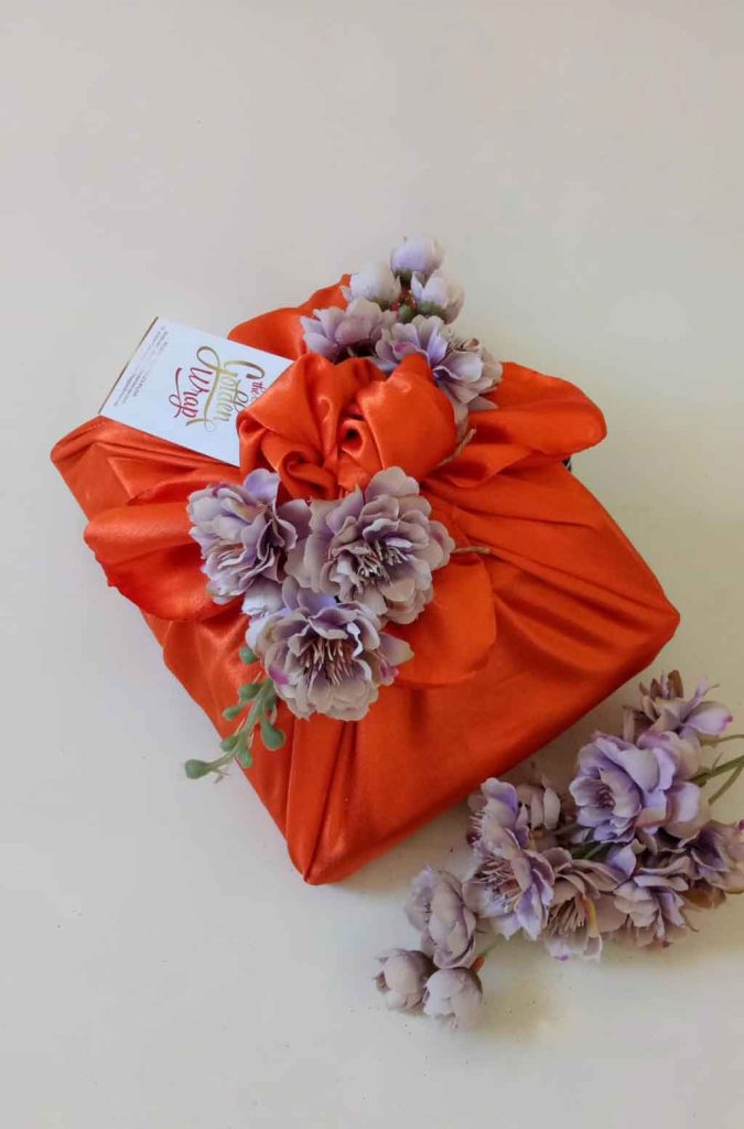 A square box wrapped in red cloth